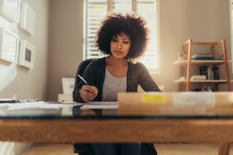 A woman sitting at a desk and working on a piece of paper: EOR in Guatemala